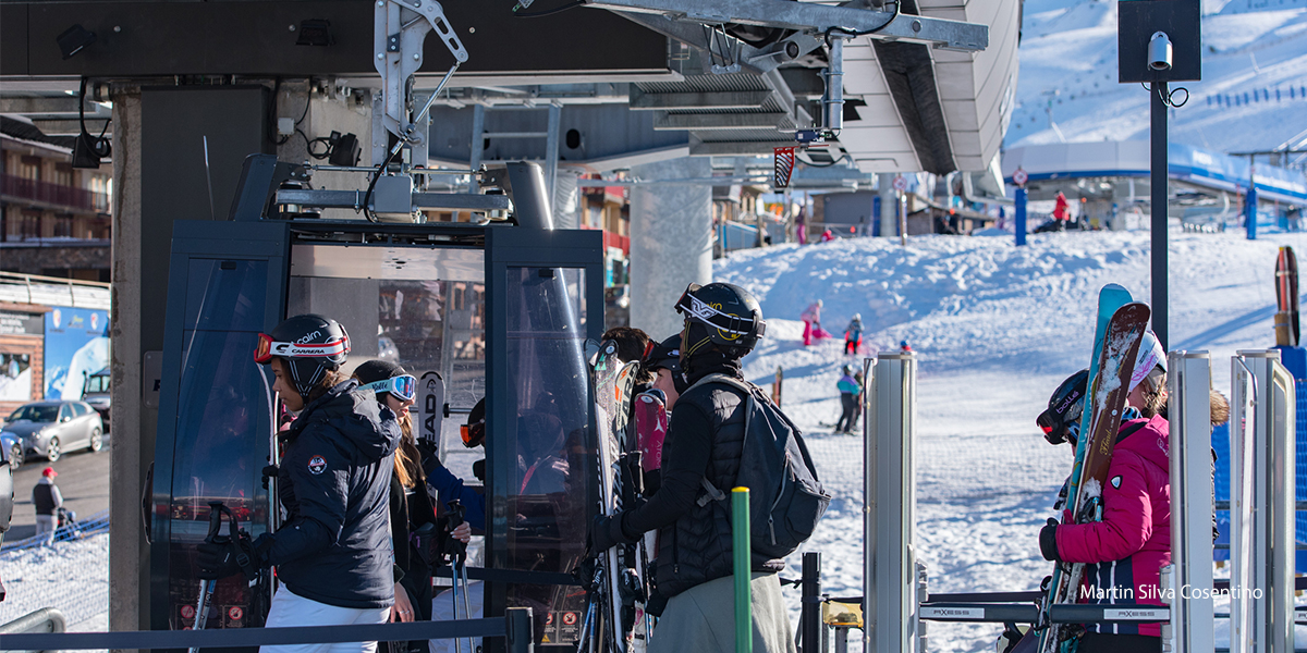 skiers getting on ski lift